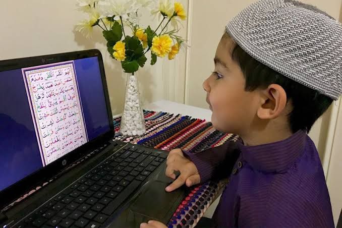Child learning Noorani Qaida on laptop with online Quran tutor