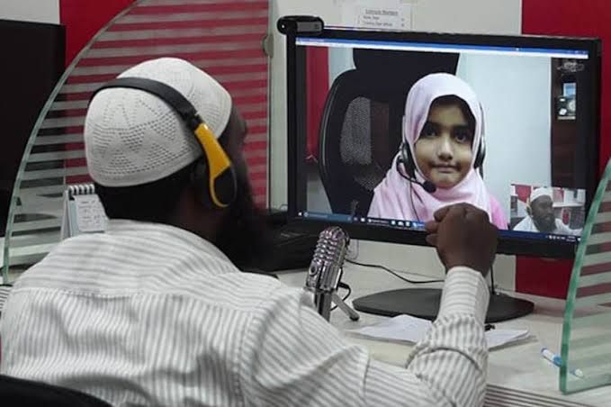 Online Quran tutor teaching a young girl student via video call