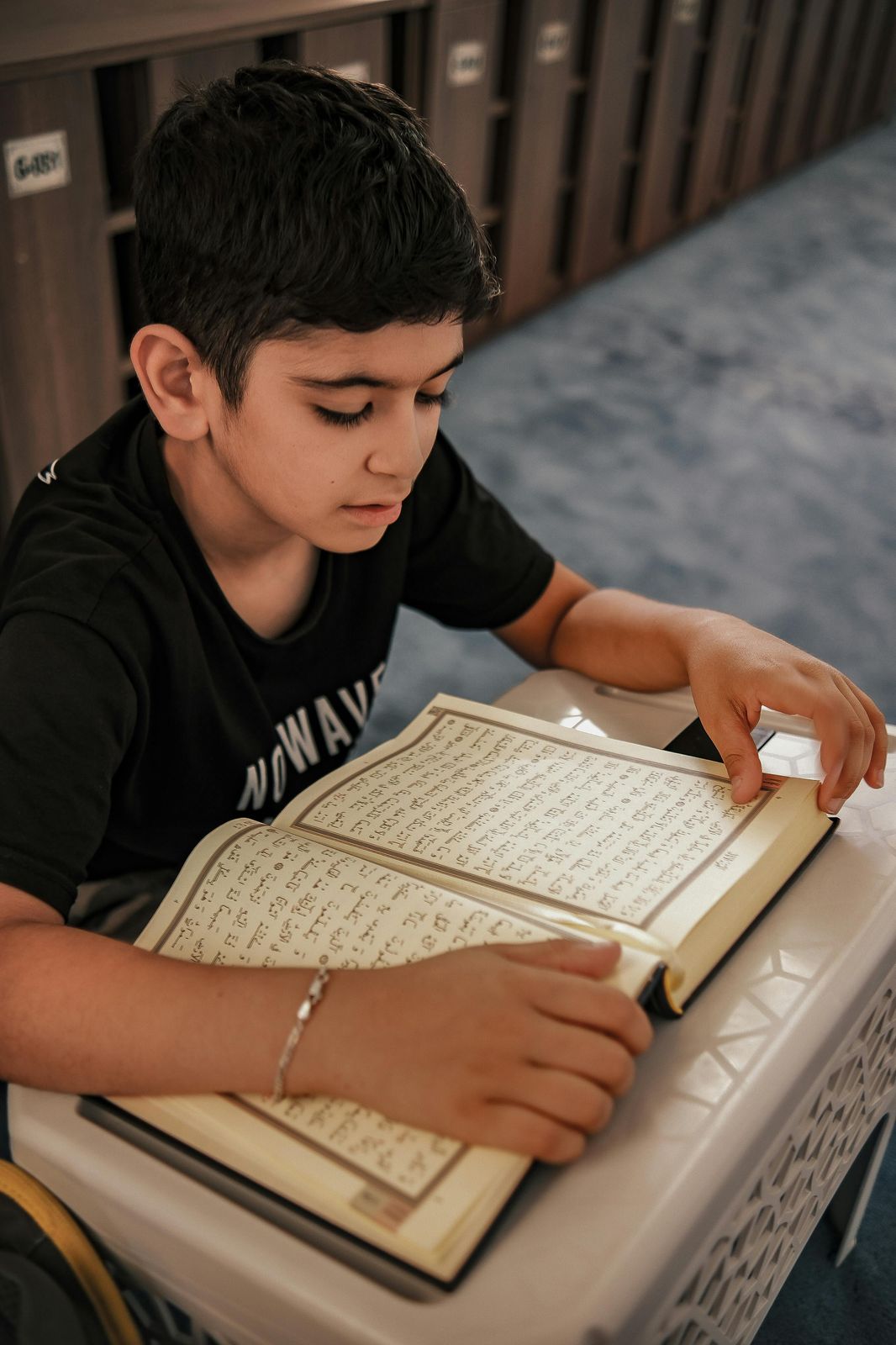 Teen boy memorizing Quran as part of an online hifz program